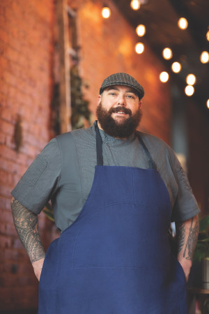Chef Mohammad standing in front of a brick wall