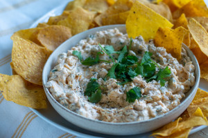 Image of Pimento Cheese Dip with Tortilla Chips, garnished with cilantro