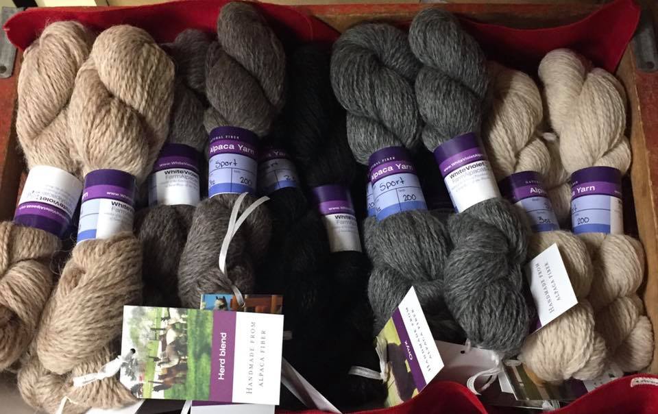 Volunteers spin alpaca fiber into handmade yarns, scarves, hats, garments and gifts